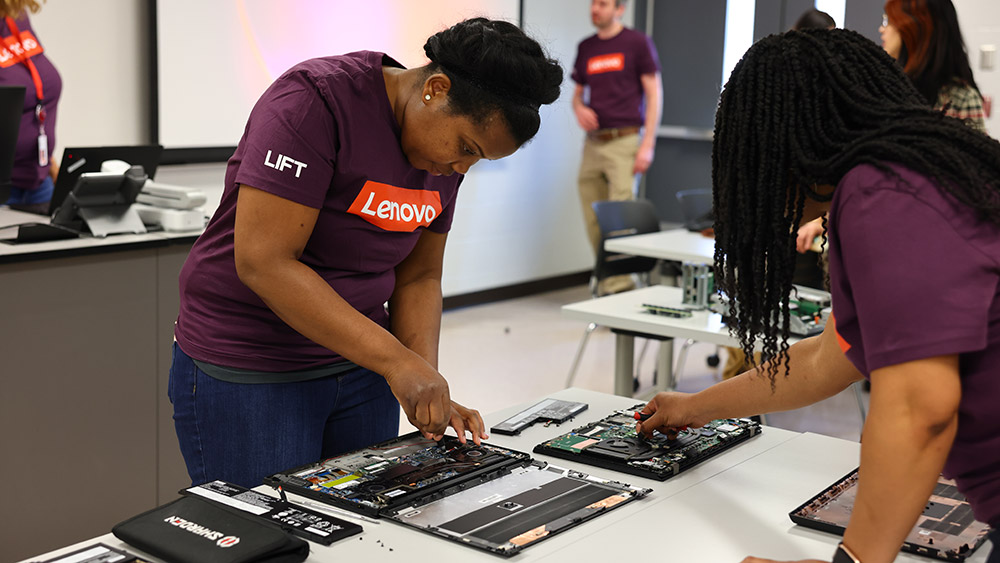 Female students practice assembling computers during a Women in Engineering event