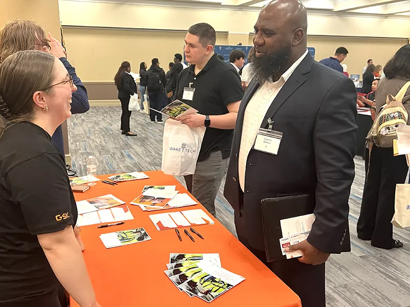 A Wake Tech student meets with a potential employer during a career fair.