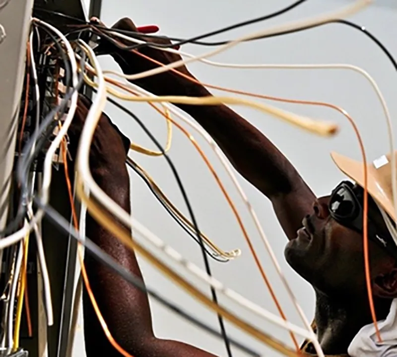 An electrician works on wiring