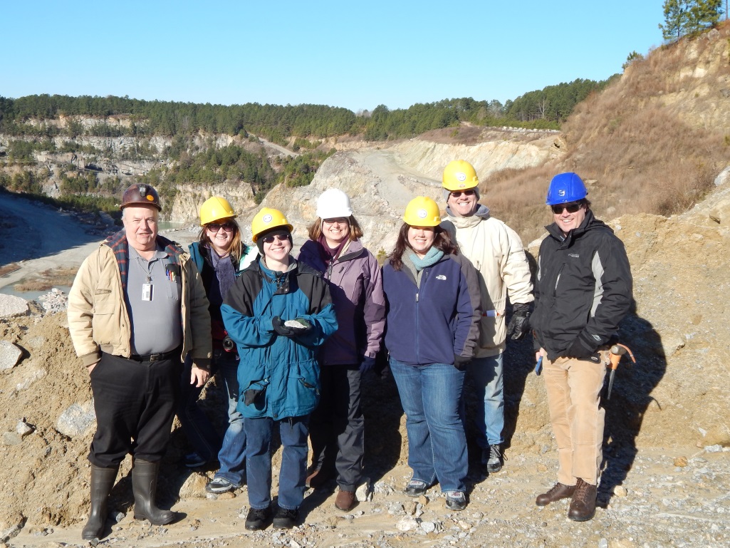 Geologists Dr. Ken Howard, Dr. Sara Rutzky, Gretchen Miller, Stephanie Rollins, Joseph Davis, and Tyler Clark pose at the Garner quarry while on a trip to select boulders in January 2014.