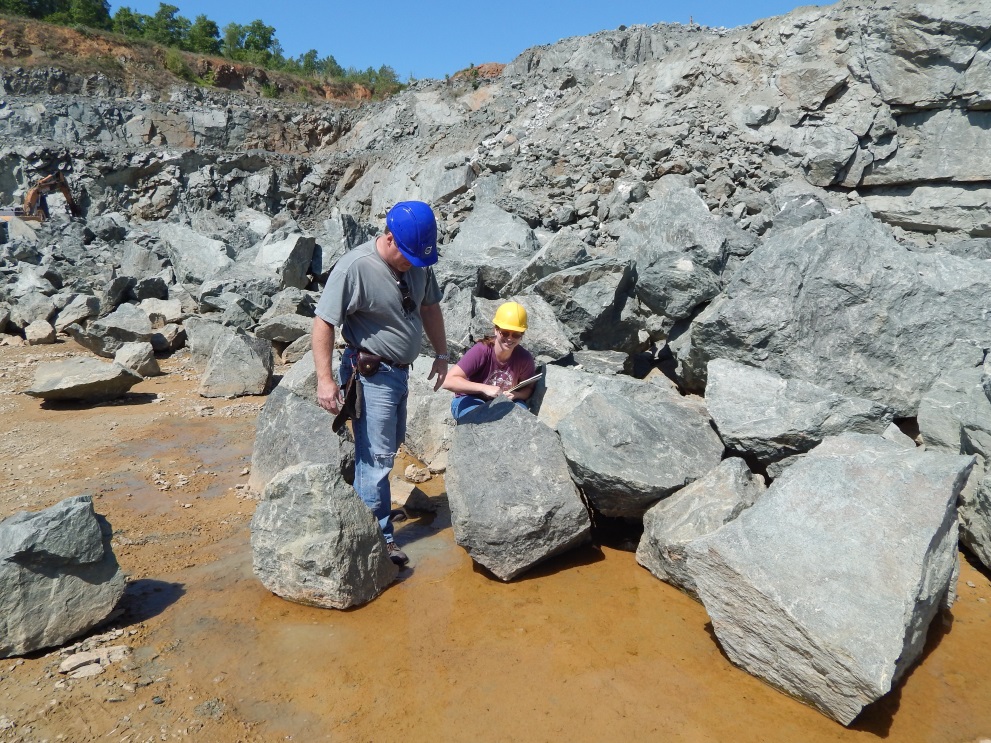 Figure 5: Geologists Tyler Clark and Dr. Sara Rutzky examine a group of boulders to see if appropriate for the OGL.