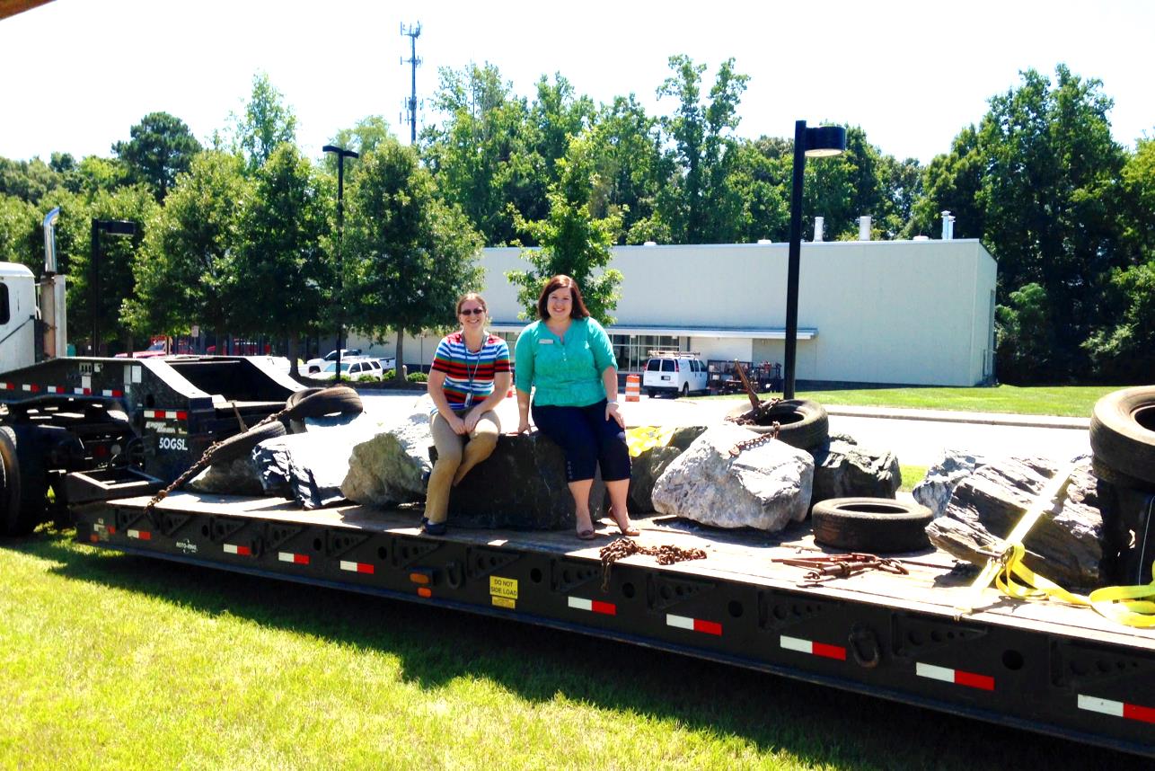 Figure 7: Geologists Dr. Sara Rutzky and Stephanie Rollins pose with the boulders as they are delivered to Wake Tech's Northern Wake Campus on August 27,  2014.