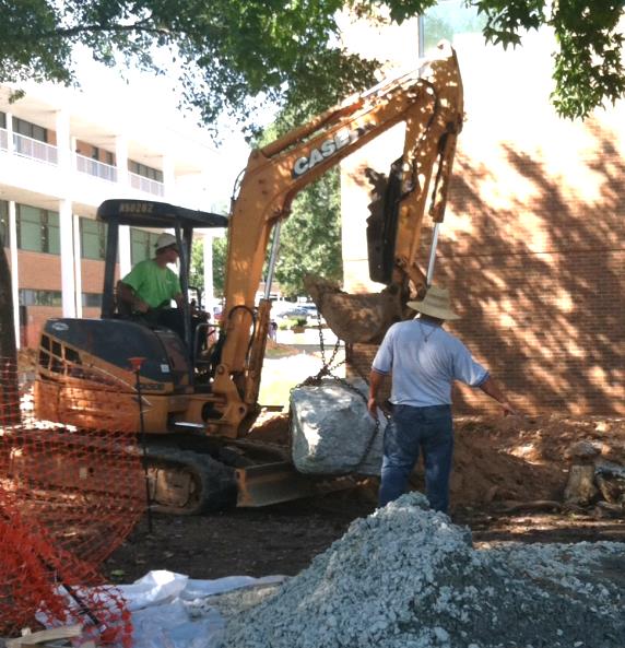 Figure 9: At Southern Wake (Main) Campus, rocks are unloaded and placed in the OGL using an excavator.