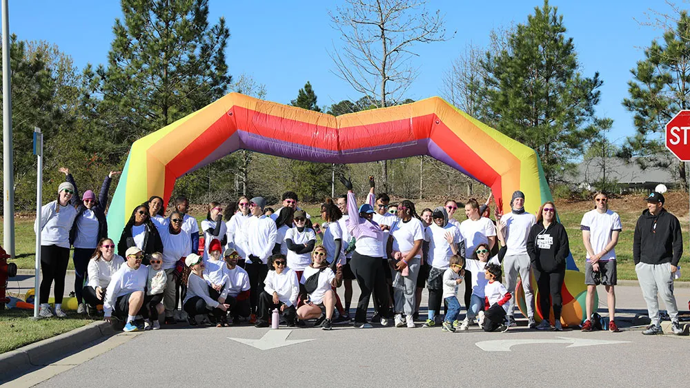 Runners celebrate after completing the 5-K Color Run.