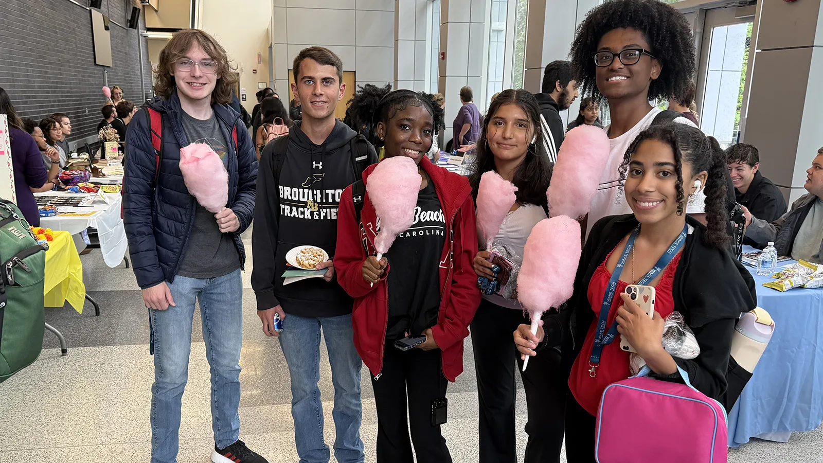 Students enjoy cotton candy during a Facts and Snacks event to introduce various clubs and organizations.