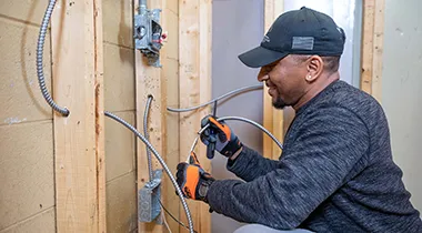 Photo of a worker installing electrical wiring