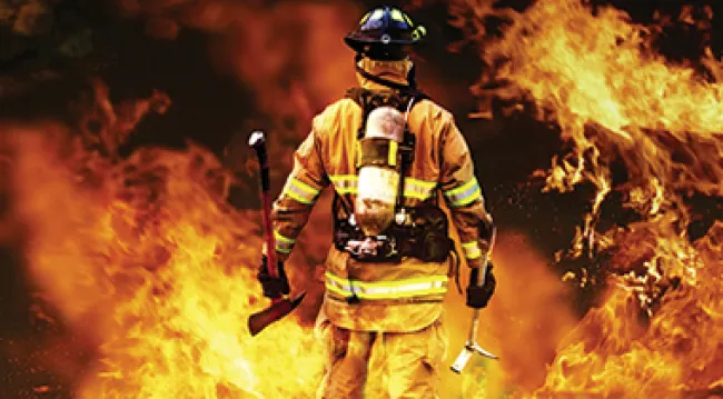 Image of a fire fighter surrounded by flames