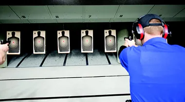 Photo of a student on a gun range shooting at a target