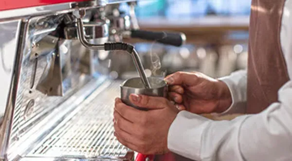 Image of a Barista making a hot beverage