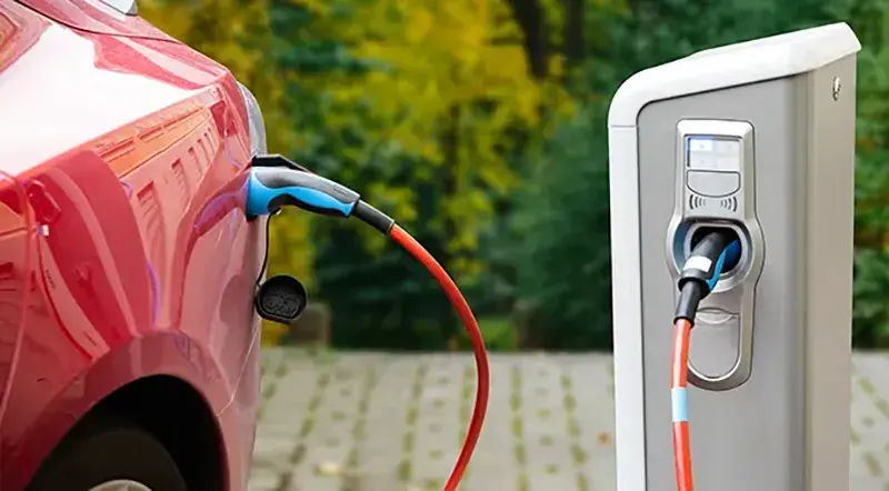 image of red electric vehicle at a charging station