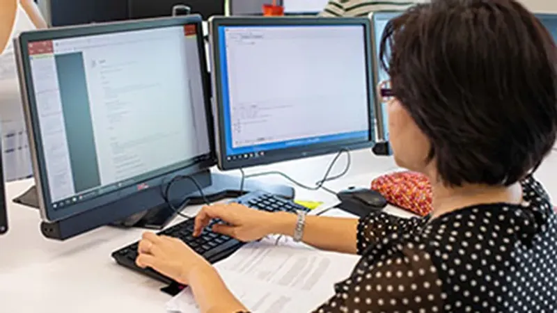 Image of a student learning computer skills at Wake Tech