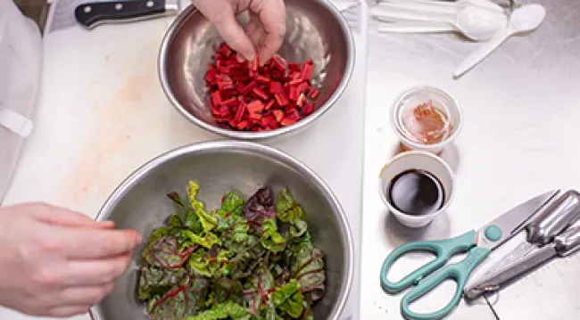 Photo of a Wake Tech culinary student preparing food