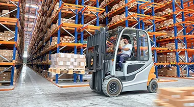 Image of a forklift operator in a warehouse