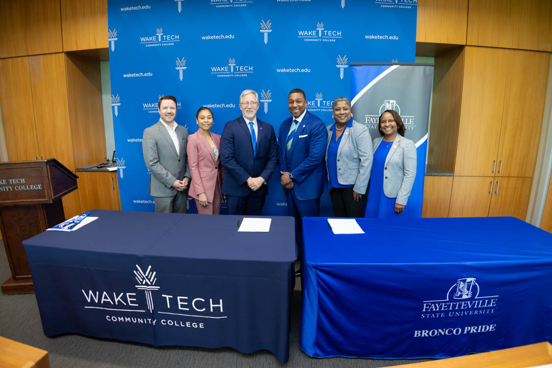 Wake Tech and Fayetteville State University officials sign an agreement to ease credit transfer from Wake Tech to FSU.