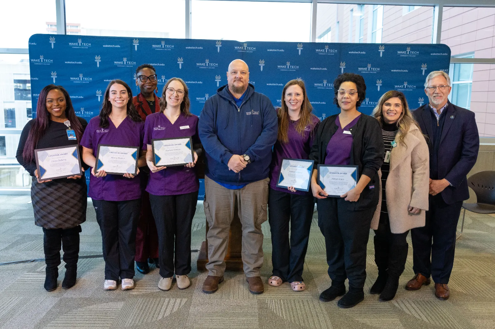 Byron Gray, center, poses with the Wake Tech Dental Hygiene students who helped him after his stroke and college officials.