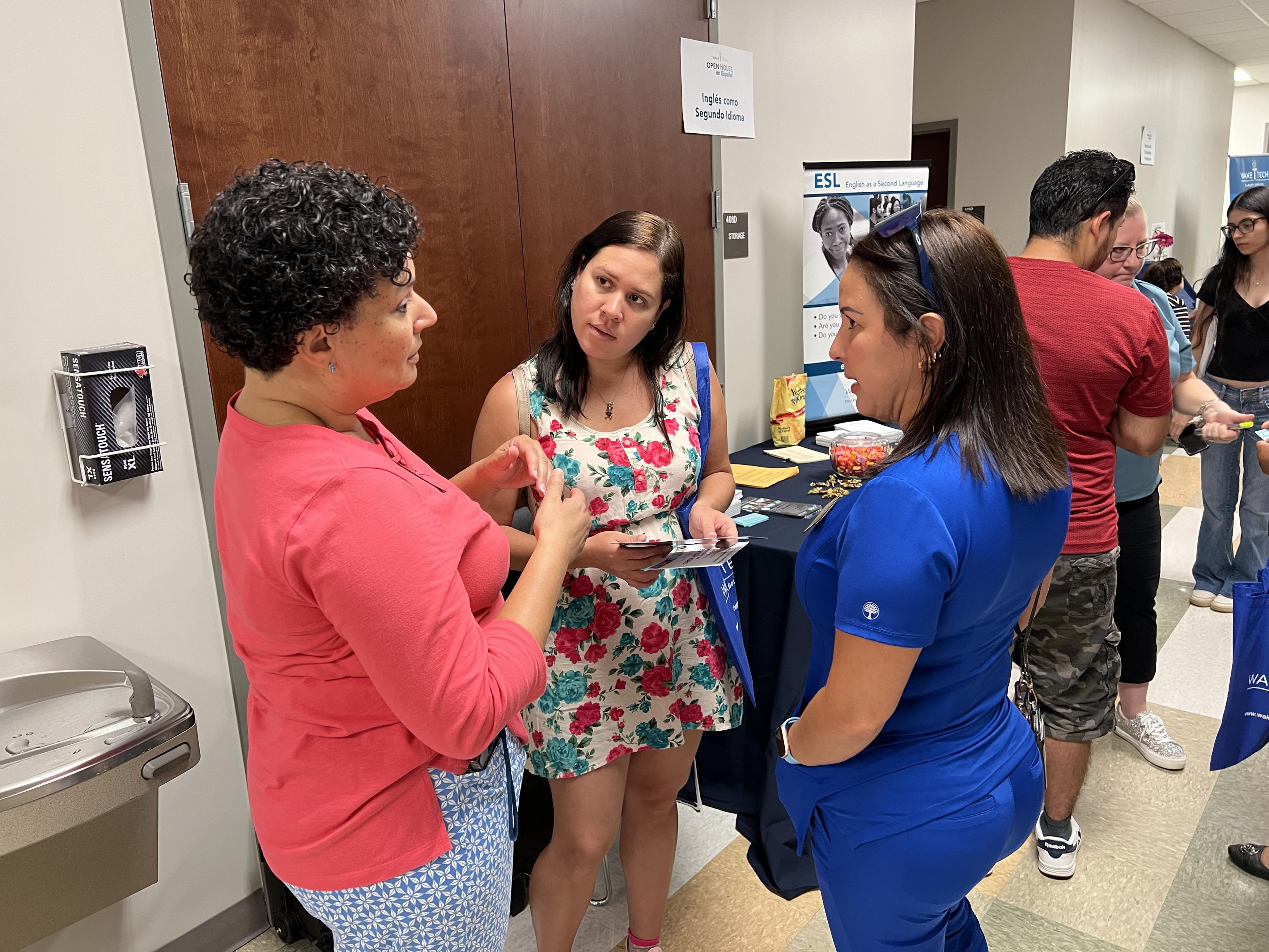 Wake Tech staff talk with prospective students and their families at the 2023 Open House en Espanol.