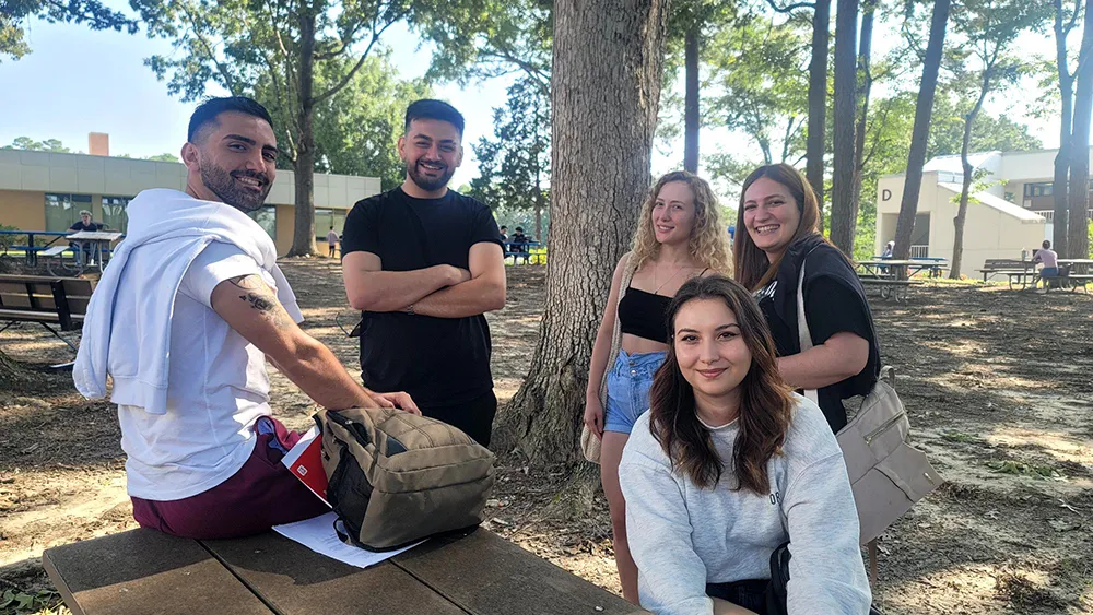 Five Wake Tech students gather on Southern Wake Campus on the first day of the 2024-25 academic year.