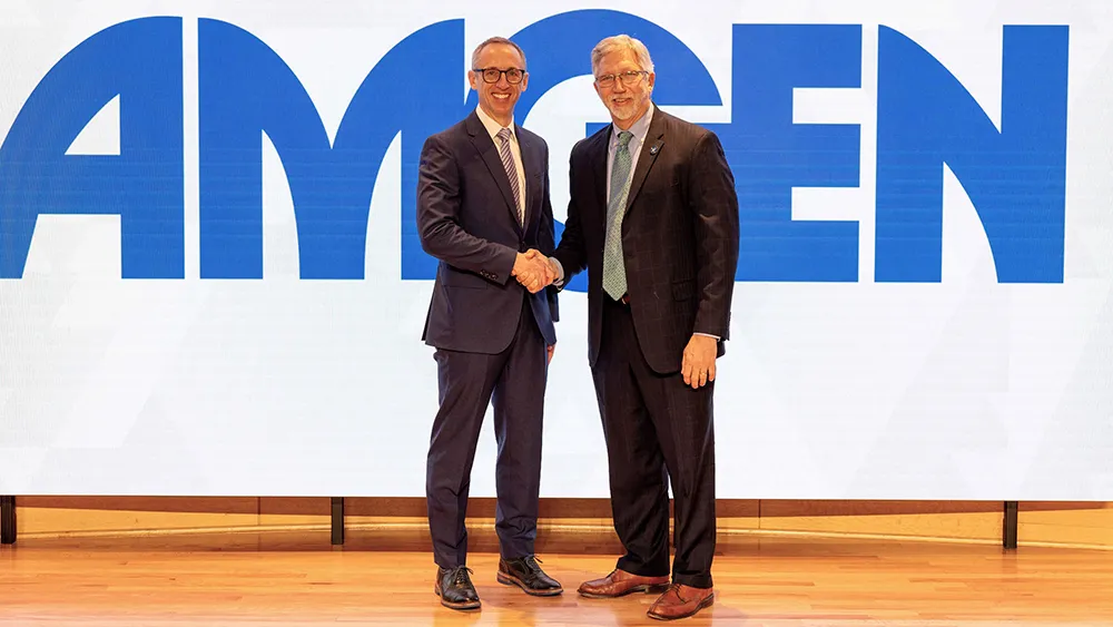 Paul Lewus, Amgen North Carolina site head, left, and Wake Tech President Dr. Scott Ralls celebrate the agreement.