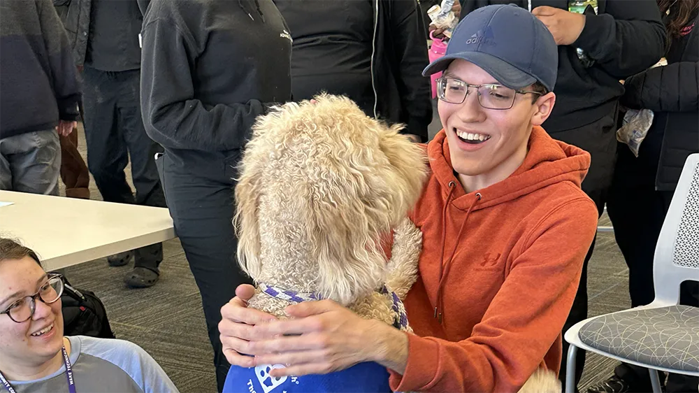 A therapy dog helps students get a break from studying.