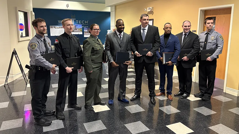 Some members of Wake Tech's latest Basic Law Enforcement Training Academy class pose for a photo after graduation.