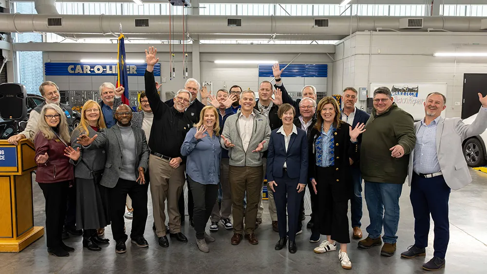 Gov. Josh Stein poses with Wake Tech faculty and administrators during a visit to the Hendrick Center for Automotive Excellence.