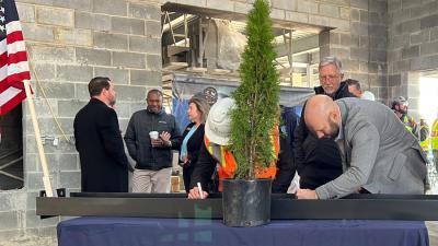 College Holds Topping-Out Ceremony for First Building at Future Campus