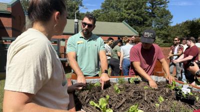 Wake Tech students are growing tomato plants in a vegetable garden on Southern Wake Campus.