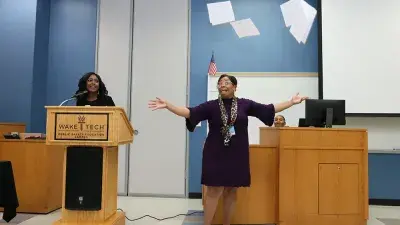 A new Wake Tech student celebrates the completion of the Eagle Start Summer Bridge Program with college staff.