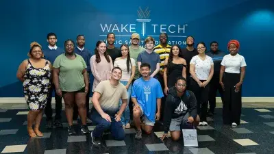 A new Wake Tech student celebrates the completion of the Eagle Start Summer Bridge Program with college staff.