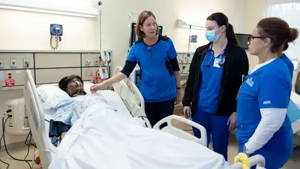 Kathy Spade discusses a patient simulation scenario to Wake Tech Nursing students.