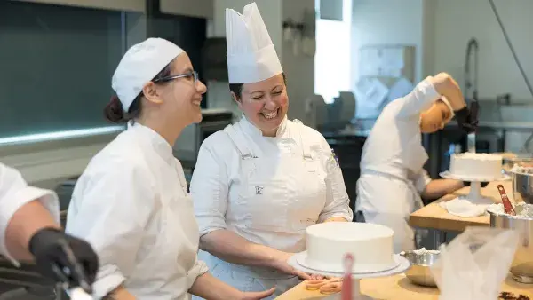 Chef Melissa Attanas shares a laugh with a student during a baking class.