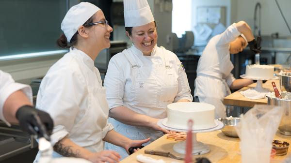 Chef Melissa Attanas talks with a student during a baking class.