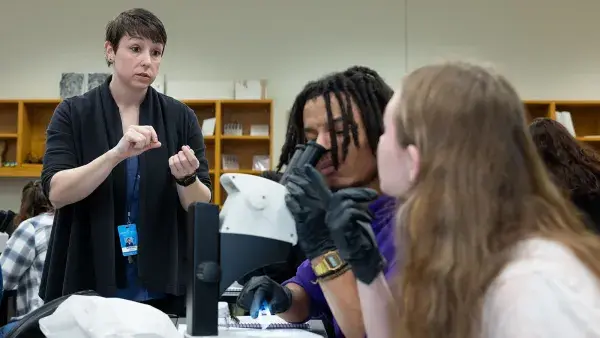 Forensic Science Instructor Sandi VanOverbake tells students how to inspect a glass fragment.